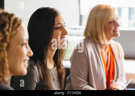 Businesswomen listening in office meeting Stock Photo