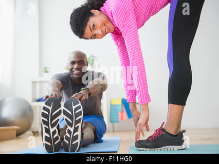 Couple stretching in gym Stock Photo