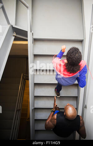 Couple jogging on staircase Stock Photo