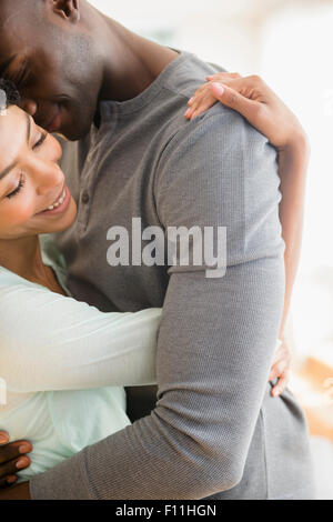 Close up of smiling couple hugging Stock Photo