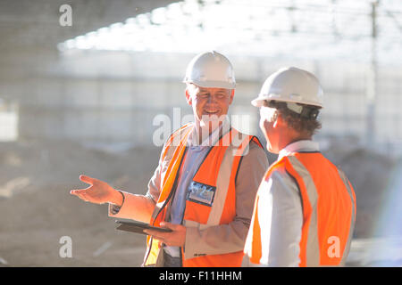 Caucasian architects using digital tablet at construction site Stock Photo