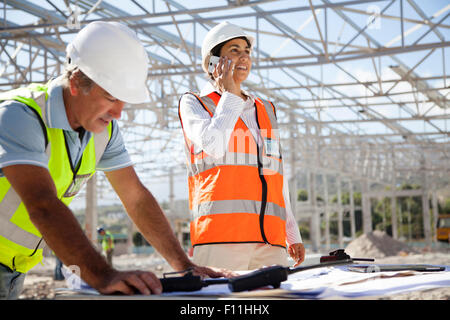 Architects working at construction site Stock Photo