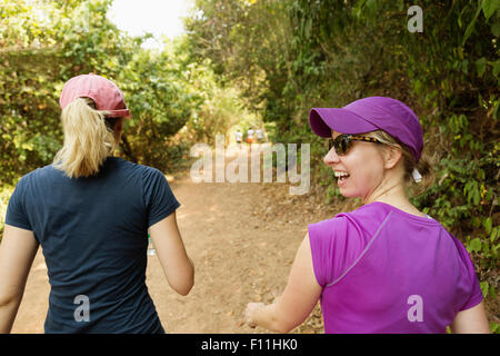 Women walking on remote dirt path Stock Photo