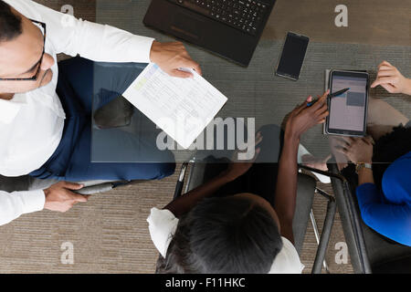Overhead view of business people talking in office meeting Stock Photo