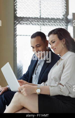 Business people using laptop in hotel lobby Stock Photo