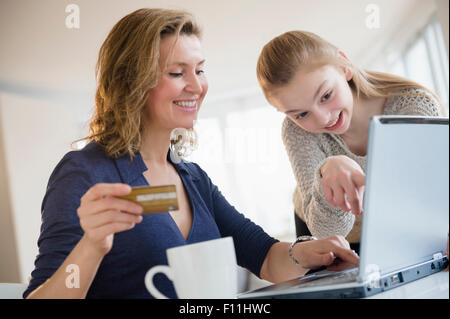 Caucasian mother and daughter shopping online Stock Photo