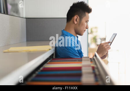 Chinese businessman using digital tablet in office Stock Photo