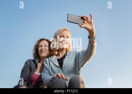 Low angle view of Caucasian women taking selfie Stock Photo
