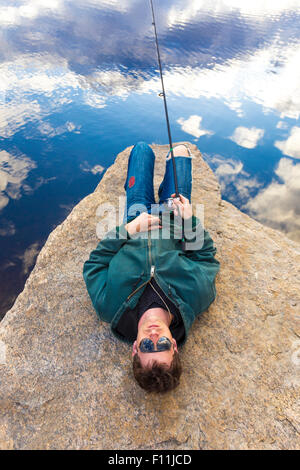 Caucasian man fishing in remote lake