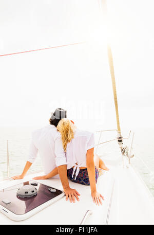 Couple cuddling on deck of sailboat Stock Photo