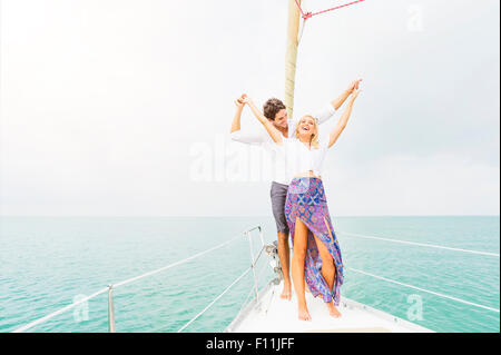 Couple dancing on deck of sailboat Stock Photo