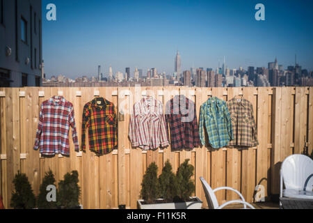 Flannel shirts hanging to dry in urban backyard, New York, New York, United States Stock Photo