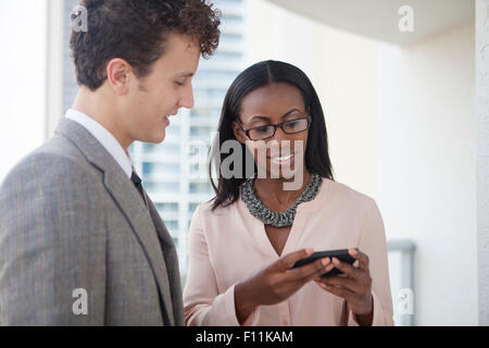 Business people using cell phone in office Stock Photo