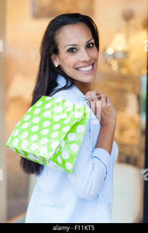 Hispanic woman shopping outdoors Stock Photo