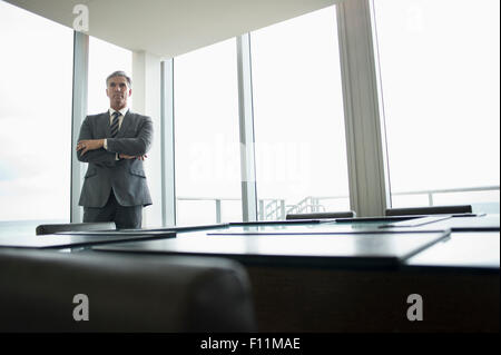 Caucasian businessman standing in empty conference room Stock Photo