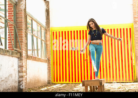 Hispanic woman balancing on platform Stock Photo