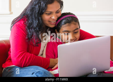 Indian mother and daughter using laptop Stock Photo