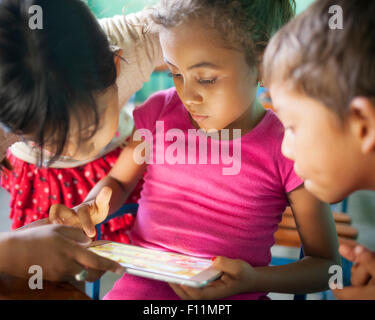 Students using digital tablet in classroom Stock Photo