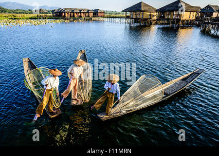 Asian fishermen fishing in canoes on river Stock Photo