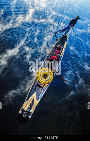Asian father and daughter rowing in canoe on river Stock Photo