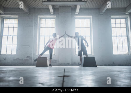 Silhouette of athletes high-fiving near platforms Stock Photo