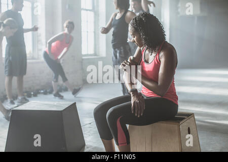 Athlete listening to mp3 player in gym Stock Photo
