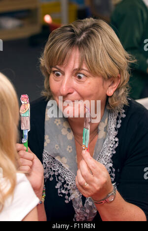 Female teacher with her pupils in classroom Stock Photo - Alamy
