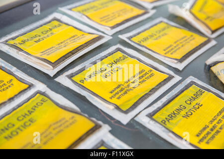 Parked car with multiple Parking Charge Notice stickers on the windscreen. Stock Photo