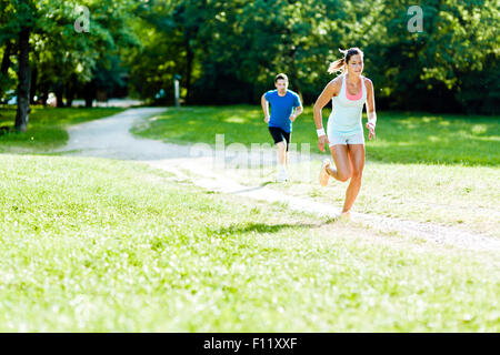 Young people jogging and exercising in nature Stock Photo