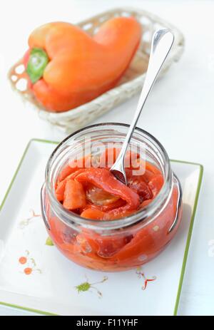 Strips of roasted red bell peppers in a jar. Stock Photo