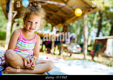 beautiful curly haired young girl smiling outdoors f11yn7