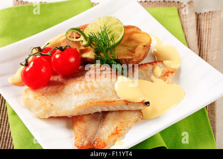 Pan fried fish fillets and Hollandaise sauce Stock Photo