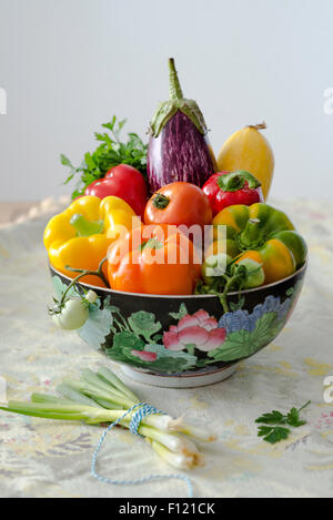 A colorful bowl filled with fresh summer vegetables Stock Photo