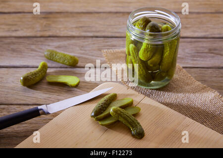 bottled pickles cucumbers in vintage wooden table Stock Photo