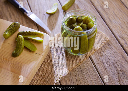 bottled pickles cucumbers in vintage wooden table Stock Photo