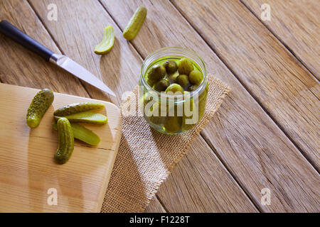bottled pickles cucumbers in vintage wooden table Stock Photo
