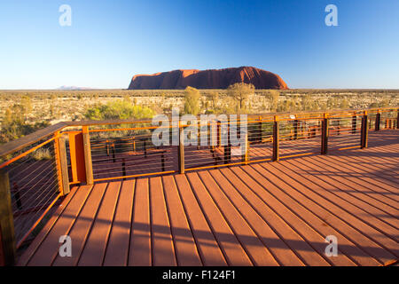 Majestic Uluru and the viewing platform at sunrise on a clear winter's morning in the Northern Territory, Australia Stock Photo