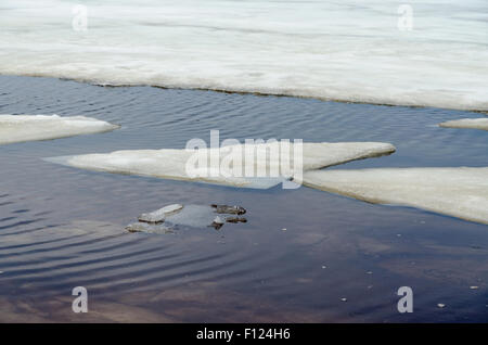 Melting ice on  sandy beach of Upper Peninsula, Michigan Stock Photo