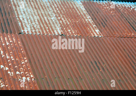 Rusty corrugated iron (sometimes referred to as tin) roof on an old barn. Stock Photo