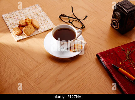 Morning breakfast coffee with vintage red notebook and biscuits Stock Photo