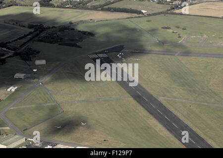 AJAXNETPHOTO. 2011. LEE ON SOLENT, ENGLAND. - AERIAL VIEW - LOOKING NORTH EAST SHOWING PART OF MAIN RUNWAY AND AIRFIELD PERIMITER ROAD WITH GOSPORT STUBBINGTON ROAD BEYOND. PHOTO:JONATHAN EASTLAND/AJAX REF:D2110209 1564 Stock Photo