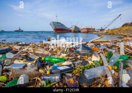 COLON, PANAMA - APRIL 15, 2015: Waste and pollution washing on the shores of the beach in city of Colon in Panama Stock Photo