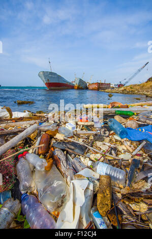 COLON, PANAMA - APRIL 15, 2015: Waste and pollution washing on the shores of the beach in city of Colon in Panama Stock Photo