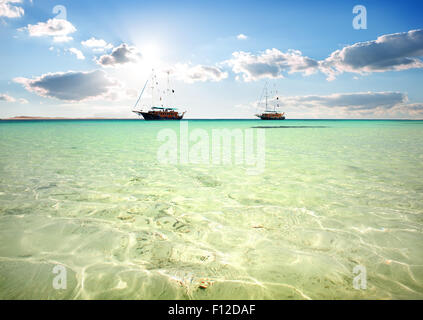 Two sailboats in turquoise sea under sunlight Stock Photo