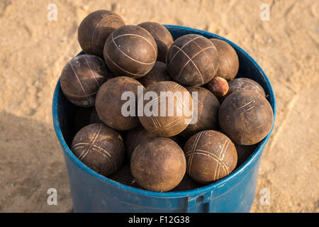 In the picture a basket full of used balls to play ballgame( Bocce,Pentanque) on the beach. Stock Photo