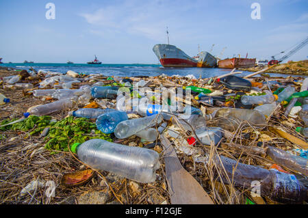 COLON, PANAMA - APRIL 15, 2015: Waste and pollution washing on the shores of the beach in city of Colon in Panama Stock Photo