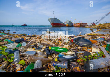 COLON, PANAMA - APRIL 15, 2015: Waste and pollution washing on the shores of the beach in city of Colon in Panama Stock Photo