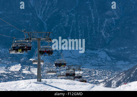 A chairlift is carrying skiers up to the Belalp ski resort in Switzerland (Valais canton). Stock Photo