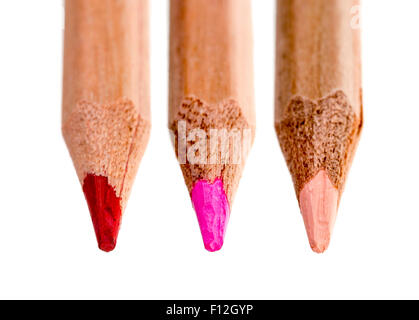 Three tips of wooden pencils in various shades of red isolated against a white background. Stock Photo