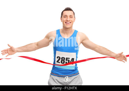 Male runner with a race number on his chest, crossing the finish line isolated on white background Stock Photo